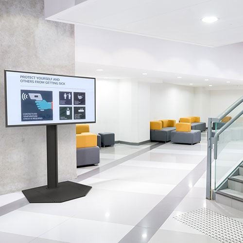 Display stand in a lobby setting with information on how to keep safe.