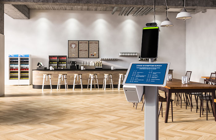 Tablet stand at a cafeteria with information about safety.