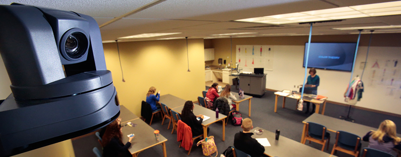 PTZ camera up close with classroom in the background