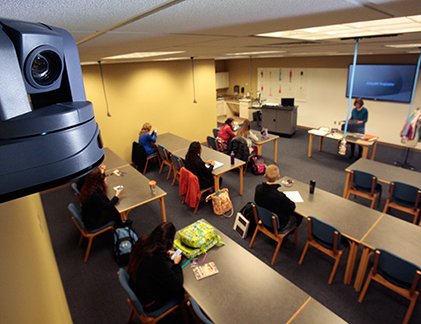 PTZ camera up close with classroom in the background