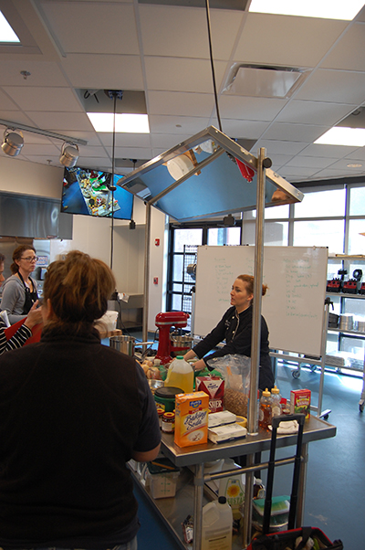 Instructor in culinary classroom teaching about making bread.