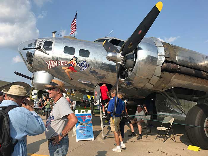Plane at the airshow with people looking at it.