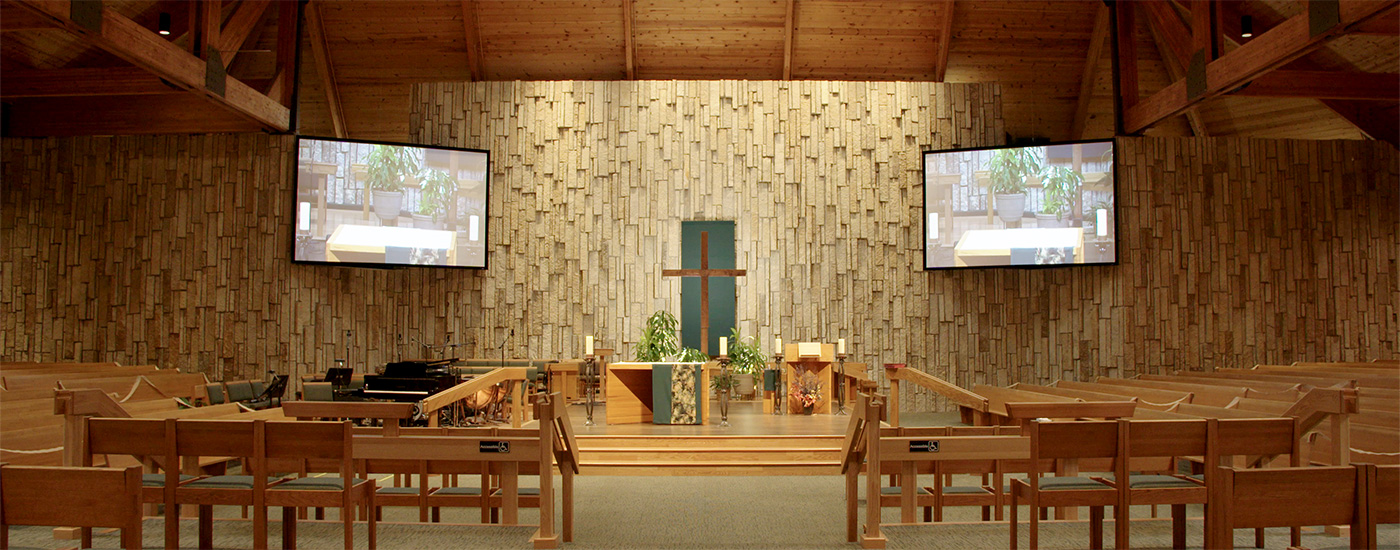 View of inside church with two Da-Lite screens flanking the altar.