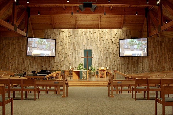 View of inside church with two Da-Lite screens flanking the altar.