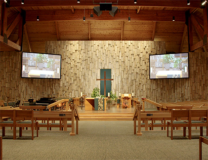 View of inside church with two Da-Lite screens flanking the altar.