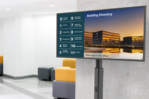 Dual Display Floor Stand for Digital Signage placed in office hallway.