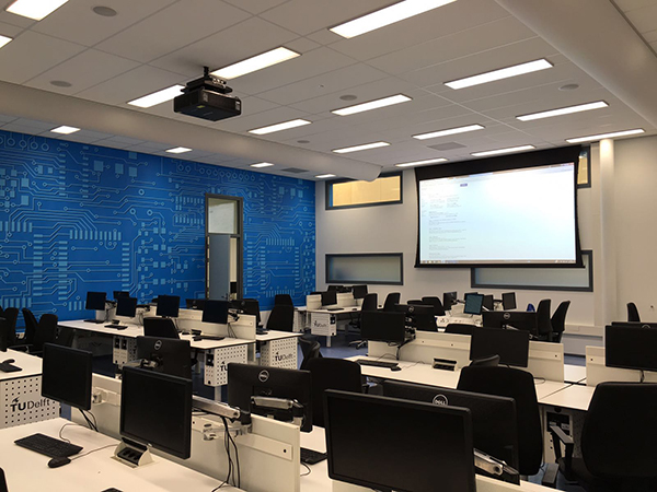 Classroom with projector, descending screen and computer desks