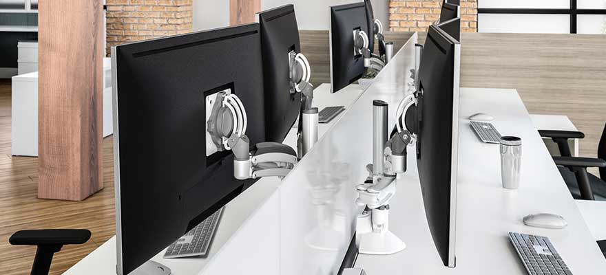 Desktop workspace with adjustable monitor arms.