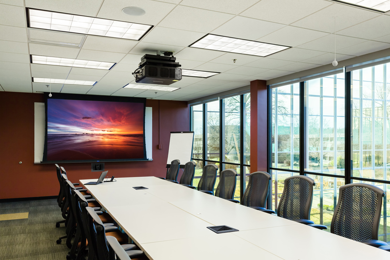 Large meeting room with overhead projector and Da-Lite screen