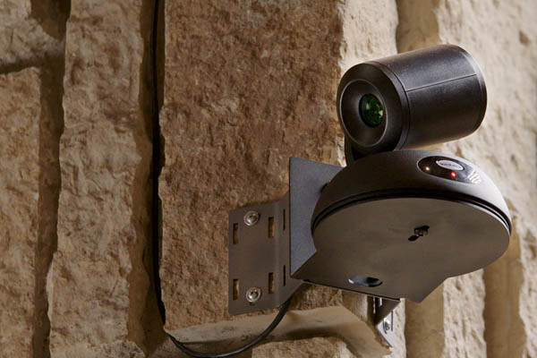 Vaddio RoboSHOT Elite NDI PTZ Camera mounted to stone wall